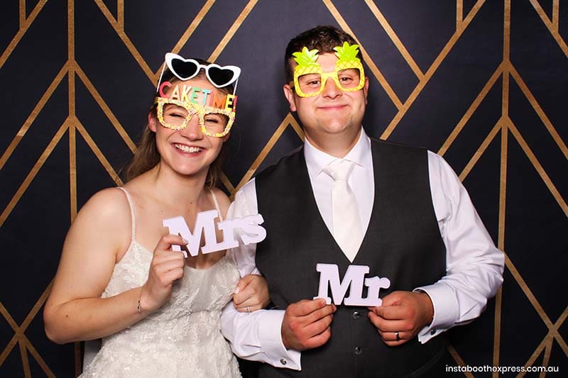 Bride and groom using Perth mirror photo booth at wedding